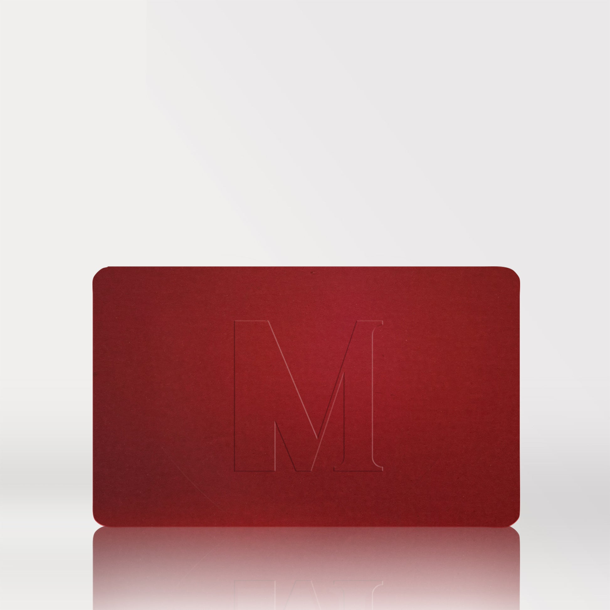 Red Dr. Diamond's Metacine gift card with a embossed letter 'M' on a white background
