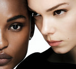 Close-up of two women's faces with a neutral background